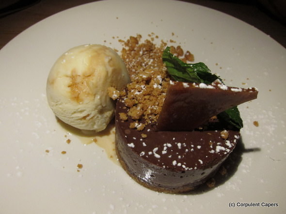 Chocolate mousse on peanut biscuit base with praline and a dollop of ice-cream